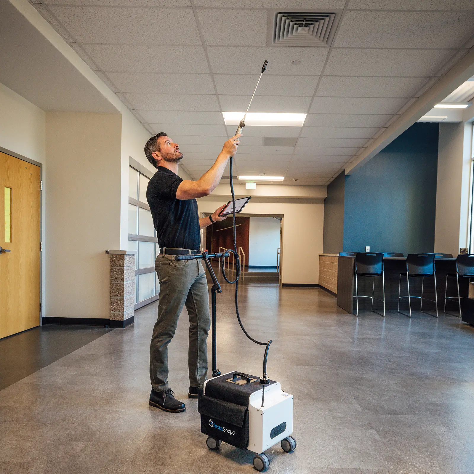 Pure Maintenance of Southern California technician scanning a ceiling vent with the InstaScope wand